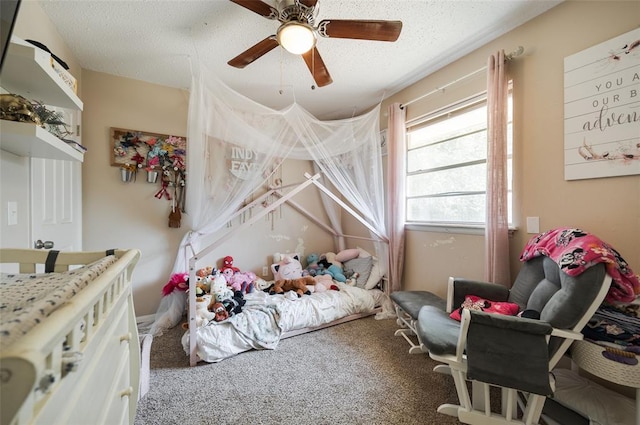 bedroom featuring a ceiling fan, carpet, and a textured ceiling