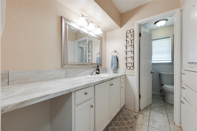 bathroom with toilet and vanity