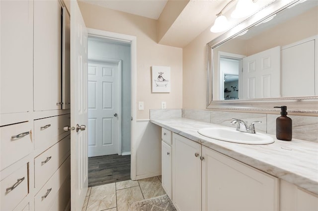 bathroom with vanity and baseboards