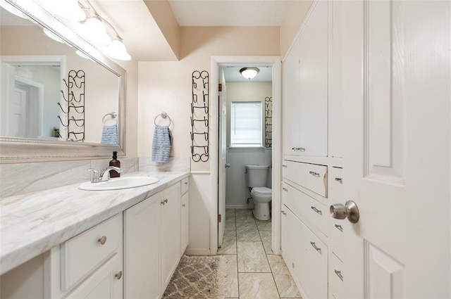 bathroom with toilet and vanity