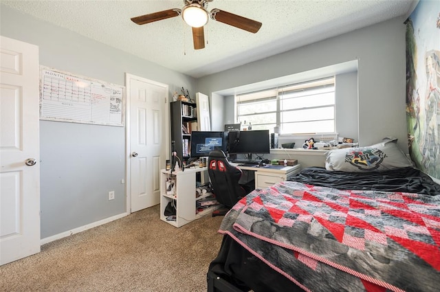 bedroom featuring light carpet, baseboards, a ceiling fan, and a textured ceiling