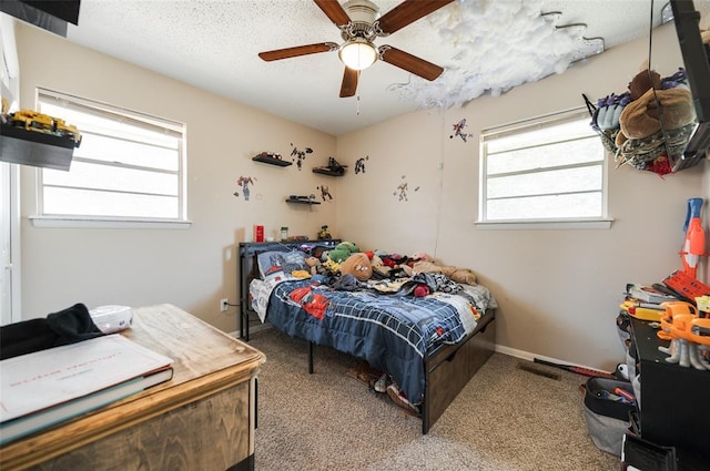 bedroom with baseboards, ceiling fan, carpet, and a textured ceiling