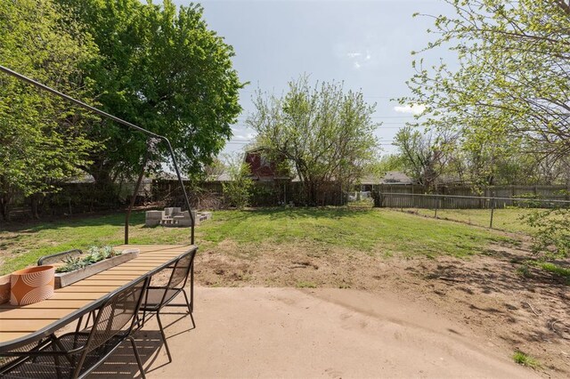 view of yard featuring outdoor dining space, a patio area, and a fenced backyard