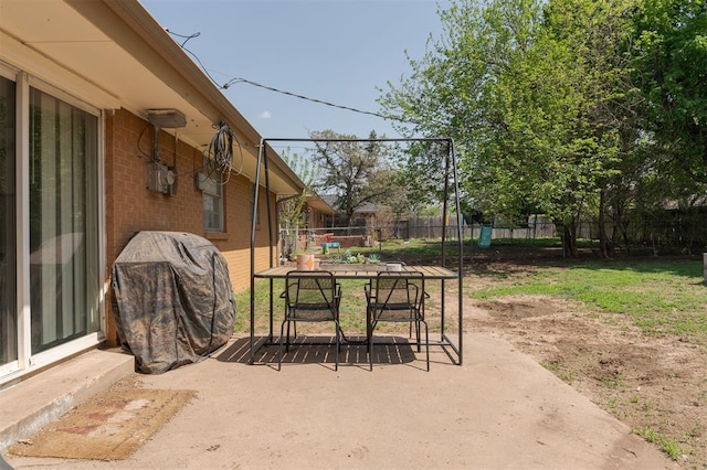 view of patio / terrace with grilling area, outdoor dining space, and a fenced backyard
