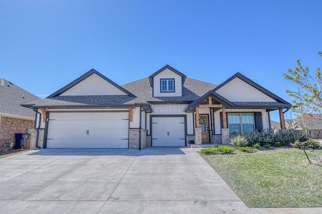 9328 NW 118th St, Yukon, OK 73099 - craftsman-style house with a front yard, driveway, a garage, and roof with shingles