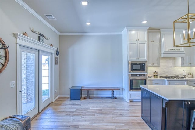 9328 NW 118th St, Yukon, OK 73099 - kitchen featuring stainless steel appliances, light countertops, crown molding, and decorative backsplash