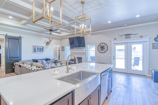 9328 NW 118th St, Yukon, OK 73099 - kitchen featuring a sink, open floor plan, light wood-type flooring, and coffered ceiling