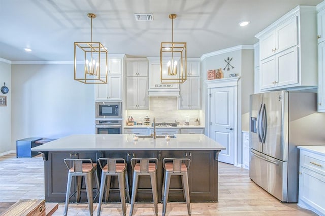 9328 NW 118th St, Yukon, OK 73099 - kitchen with crown molding, tasteful backsplash, appliances with stainless steel finishes, and a breakfast bar area