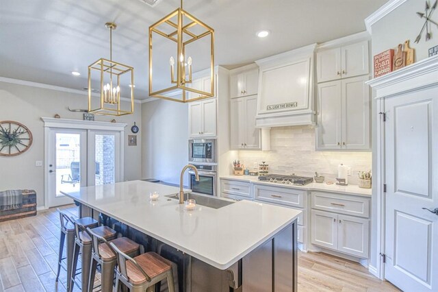 9328 NW 118th St, Yukon, OK 73099 - kitchen featuring ornamental molding, french doors, decorative backsplash, stainless steel appliances, and light wood finished floors