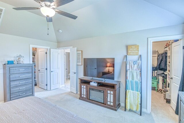 9328 NW 118th St, Yukon, OK 73099 - bedroom with ceiling fan, a closet, light colored carpet, lofted ceiling, and a walk in closet