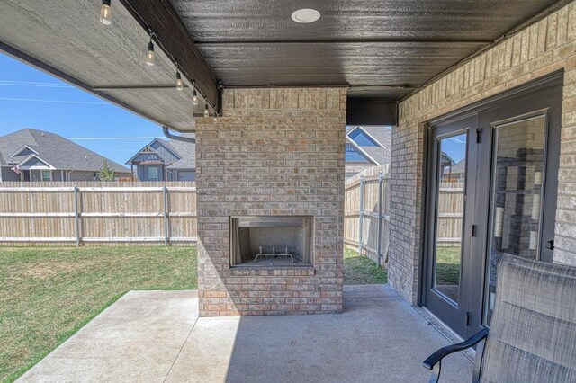 9328 NW 118th St, Yukon, OK 73099 - view of patio featuring an outdoor brick fireplace and fence