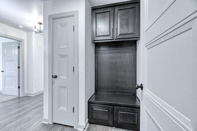 mudroom featuring baseboards and wood finished floors