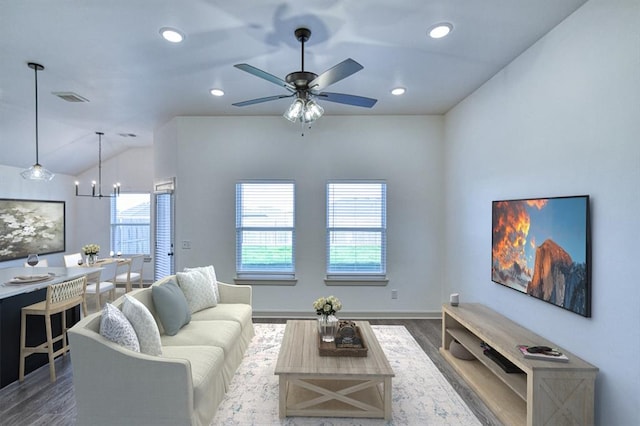 living area with wood finished floors, ceiling fan with notable chandelier, visible vents, vaulted ceiling, and recessed lighting