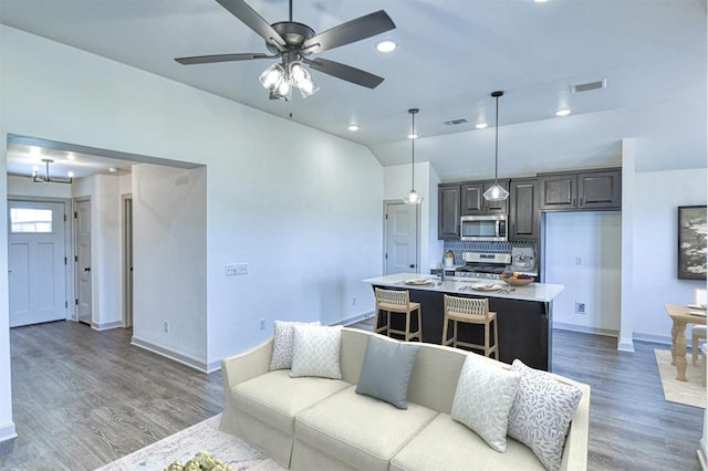 living area featuring light wood finished floors, baseboards, ceiling fan, and visible vents