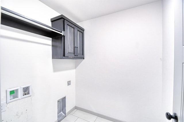 washroom with baseboards, light tile patterned floors, hookup for a washing machine, cabinet space, and electric dryer hookup