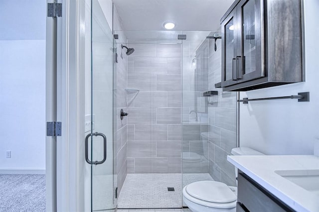 full bathroom with a shower stall, vanity, and toilet