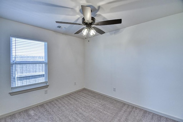 empty room featuring baseboards, ceiling fan, carpet flooring, and visible vents