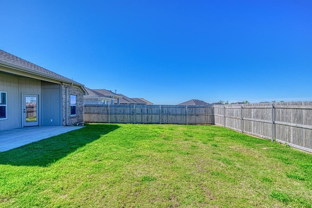 view of yard with a patio area and a fenced backyard