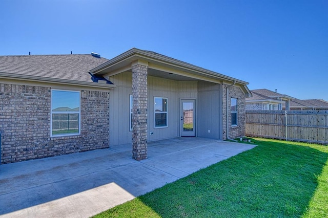 back of house with a yard, a patio, and fence