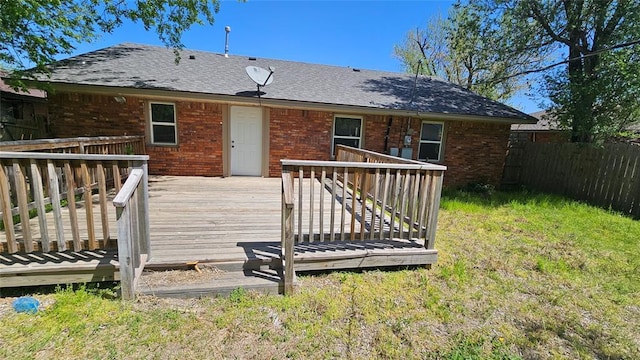 1708 NE 47th St, Oklahoma City, OK 73111 - back of house featuring brick siding, a shingled roof, a wooden deck, and fence