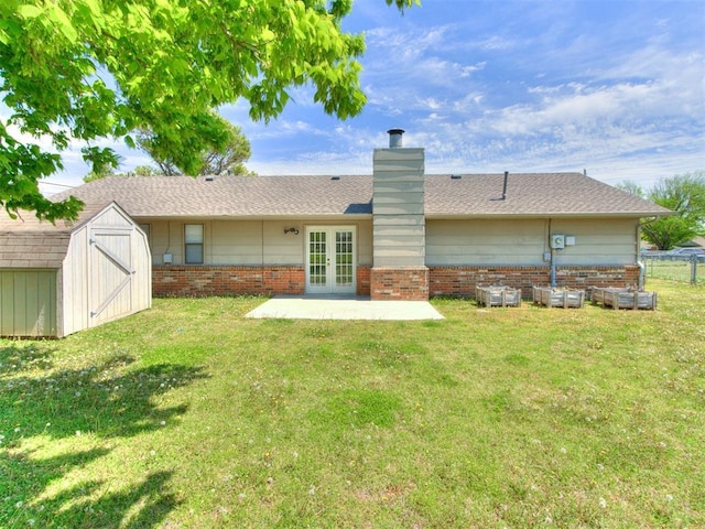 2416 Ellis Dr, Shawnee, OK 74804 - back of property with a yard, french doors, a chimney, and a storage unit