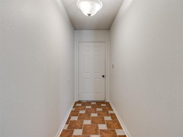 2416 Ellis Dr, Shawnee, OK 74804 - hallway featuring stone finish floor and baseboards
