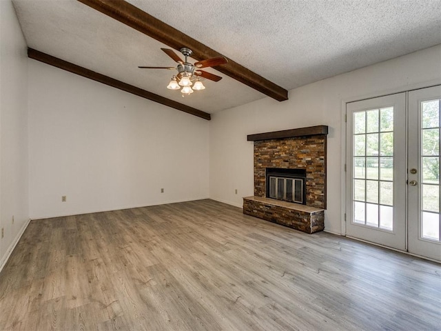 2416 Ellis Dr, Shawnee, OK 74804 - unfurnished living room featuring french doors, beamed ceiling, and wood finished floors