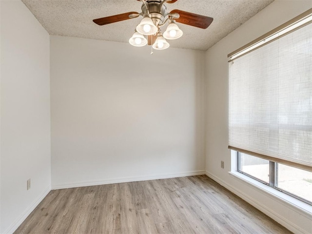 2416 Ellis Dr, Shawnee, OK 74804 - spare room with baseboards, light wood-type flooring, a textured ceiling, and a ceiling fan