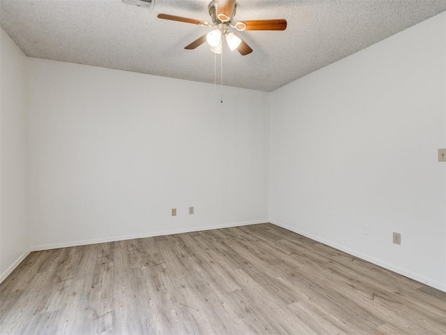 2416 Ellis Dr, Shawnee, OK 74804 - unfurnished room with ceiling fan, a textured ceiling, baseboards, and wood finished floors