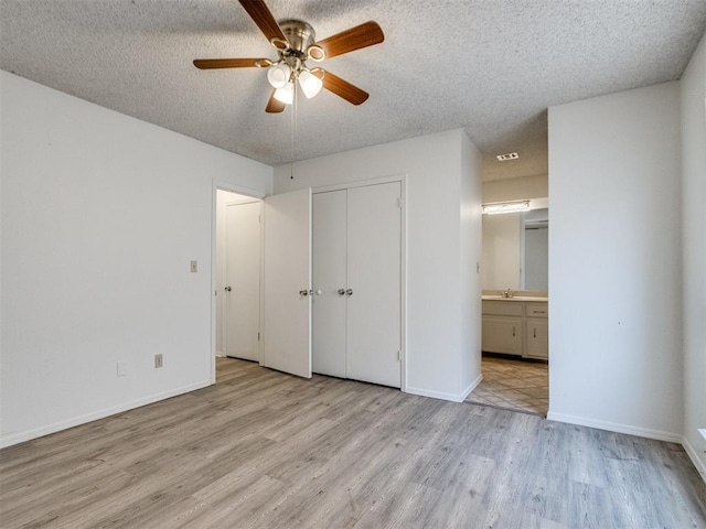 2416 Ellis Dr, Shawnee, OK 74804 - unfurnished bedroom featuring light wood-type flooring, a closet, baseboards, and a textured ceiling