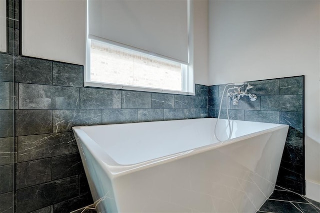 full bath featuring tile walls and a freestanding tub