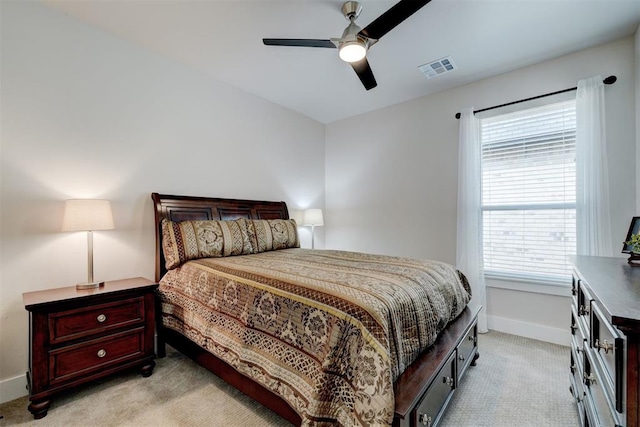 bedroom with multiple windows, visible vents, baseboards, and light carpet