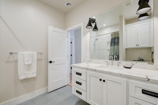 bathroom with baseboards, vanity, curtained shower, and visible vents