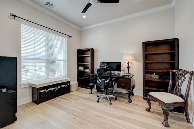office space featuring visible vents, a ceiling fan, ornamental molding, baseboards, and light wood-style flooring