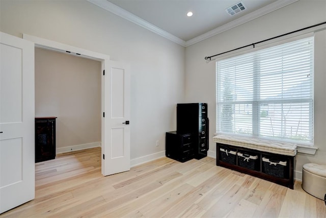 misc room featuring baseboards, light wood-style flooring, visible vents, and crown molding