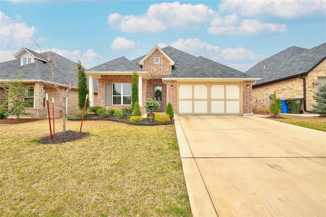 view of front of property with brick siding, driveway, a front lawn, and a garage