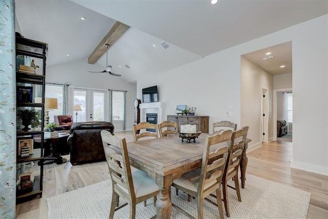dining space featuring light wood-type flooring, plenty of natural light, vaulted ceiling with beams, and recessed lighting