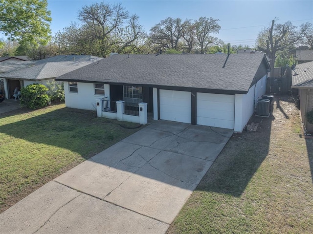 single story home featuring roof with shingles, a garage, a front yard, and concrete driveway