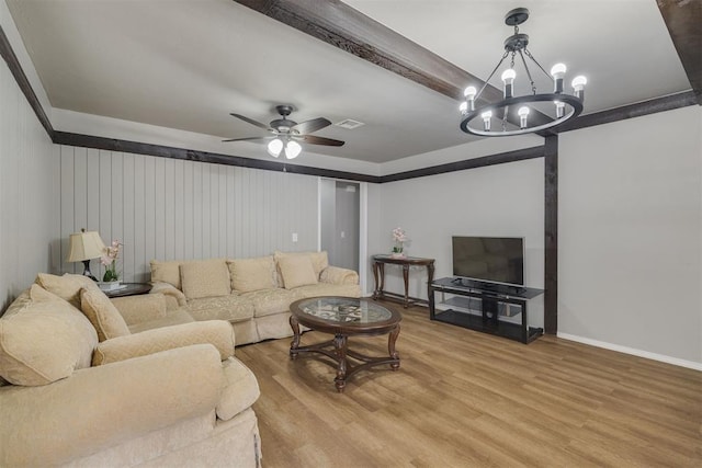 living area with light wood-style flooring, baseboards, and ceiling fan with notable chandelier