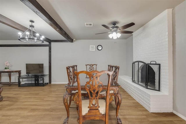 dining room featuring visible vents, beam ceiling, light wood-style floors, and ceiling fan with notable chandelier
