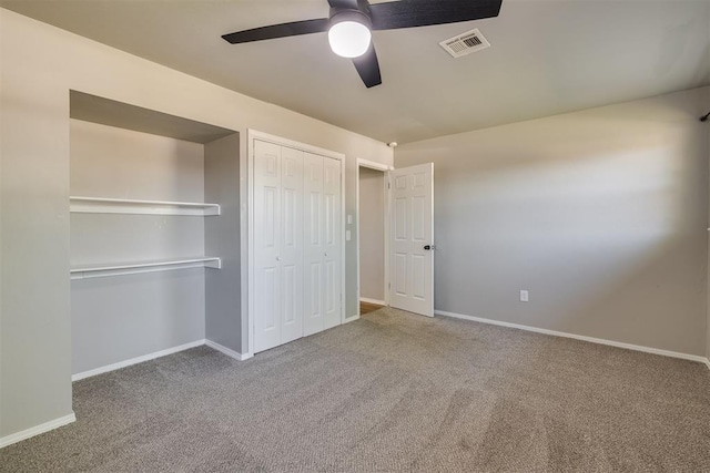 unfurnished bedroom featuring a closet, baseboards, carpet, and visible vents