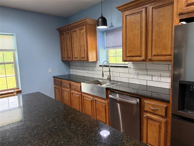 1595 County Road 1240, Tuttle, OK 73089 - kitchen featuring appliances with stainless steel finishes, brown cabinetry, decorative backsplash, and pendant lighting