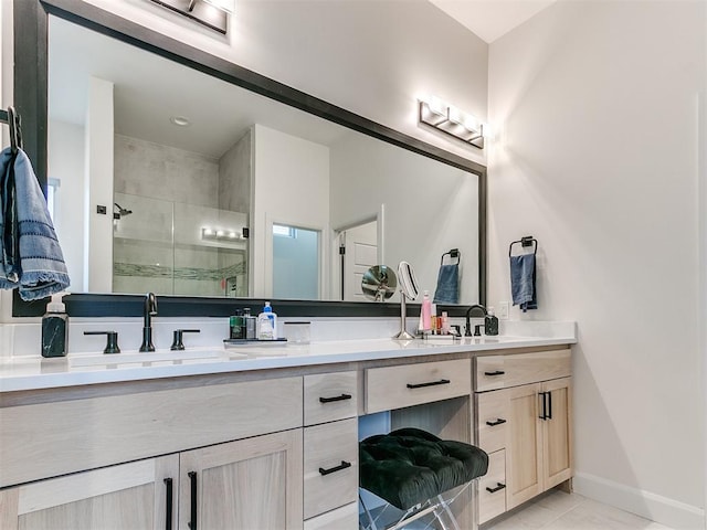 3532 Paso Robles Ter, Edmond, OK 73034 - bathroom with a shower stall, double vanity, baseboards, and a sink