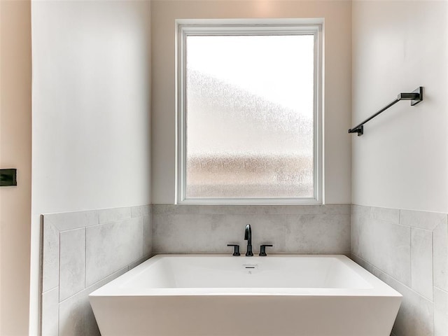 3532 Paso Robles Ter, Edmond, OK 73034 - bathroom featuring a sink, a freestanding bath, and plenty of natural light