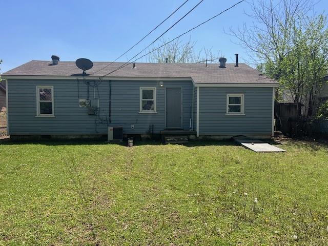 3741 SW 43rd St, Oklahoma City, OK 73119 - rear view of house featuring central AC and a lawn