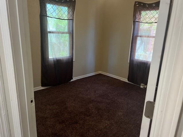 3741 SW 43rd St, Oklahoma City, OK 73119 - spare room with dark colored carpet and baseboards