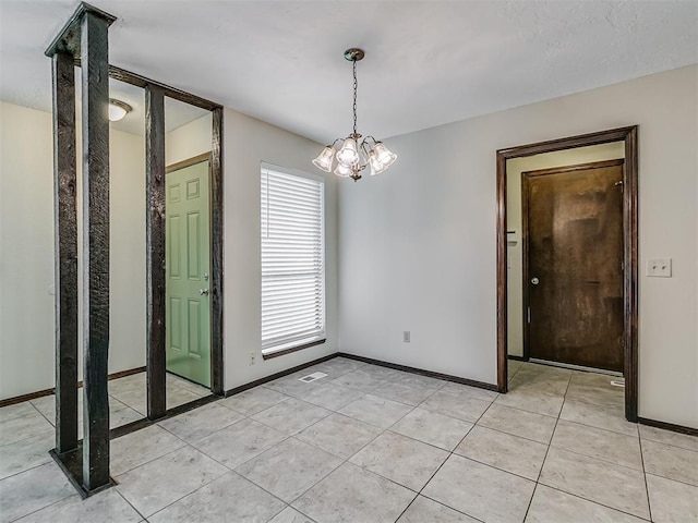 unfurnished dining area with a chandelier, light tile patterned floors, and baseboards
