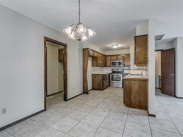 kitchen featuring an inviting chandelier, light tile patterned floors, visible vents, appliances with stainless steel finishes, and a sink