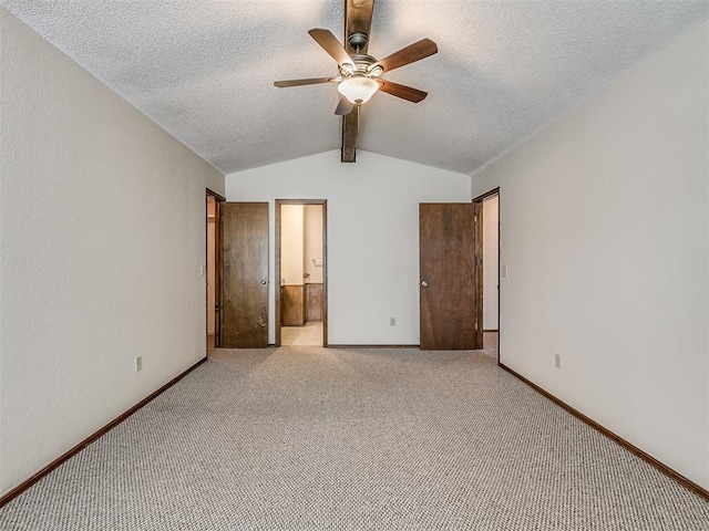 unfurnished bedroom with carpet floors, baseboards, vaulted ceiling with beams, and a textured ceiling