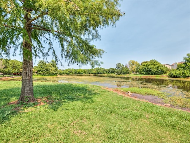 view of home's community featuring a water view and a yard
